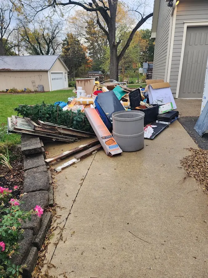 Dumpster being loaded with debris for Roofing Dumpster Rental in Libertyville